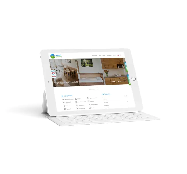 Tablet przedstawiający stronę Magic Apartments i logo